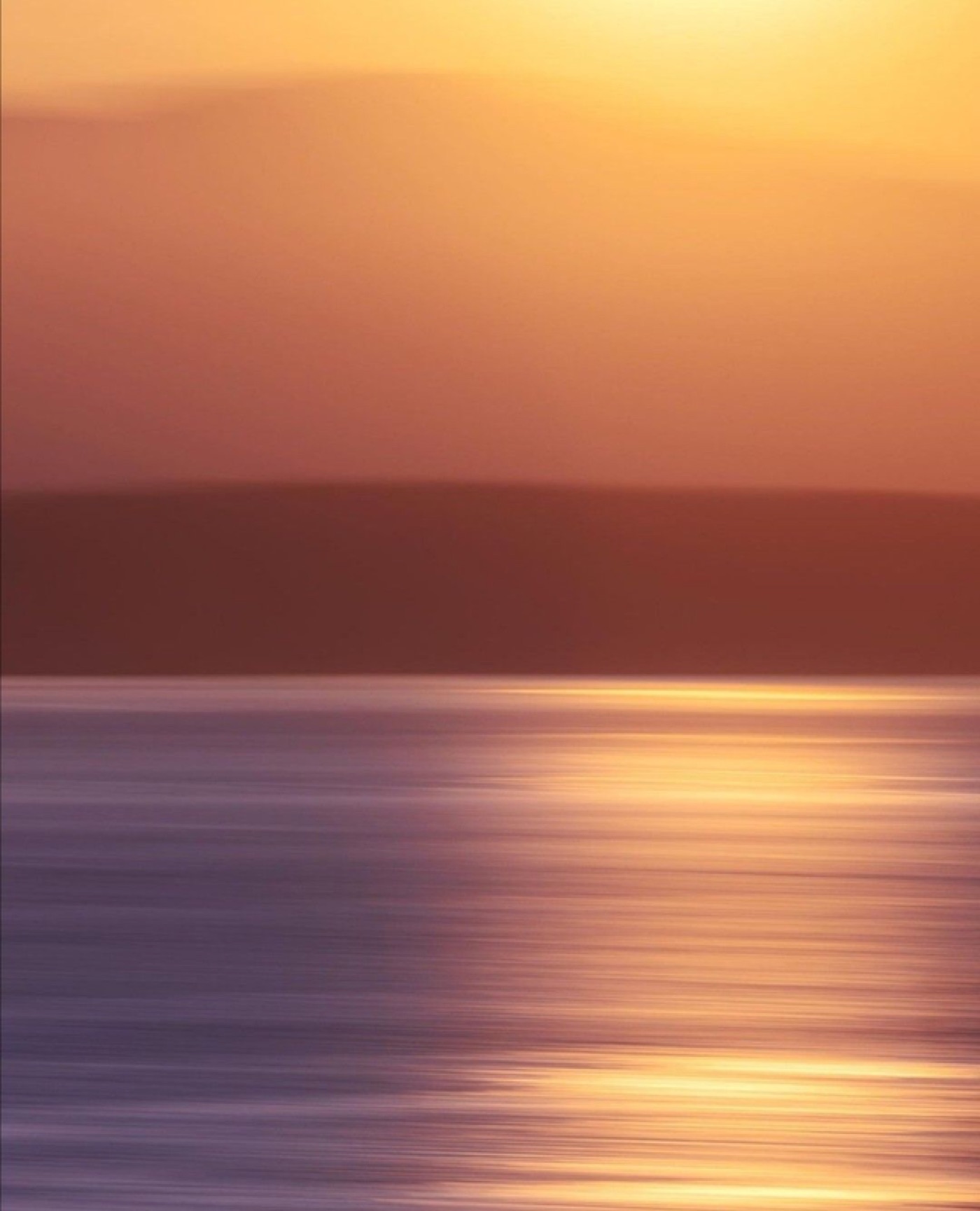 Warm sunset light over water, illustrating Opulesse's brand concept of light and colour